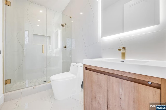 bathroom featuring vanity, toilet, marble finish floor, and a marble finish shower