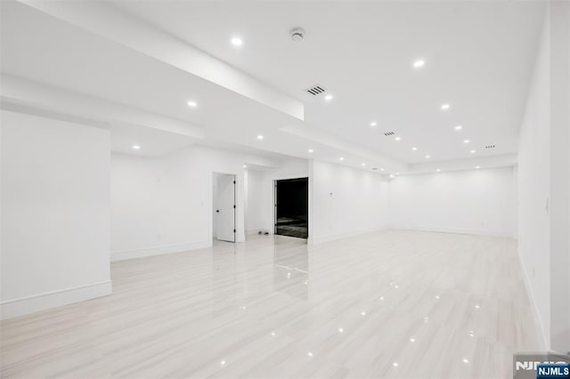 spare room featuring recessed lighting and baseboards