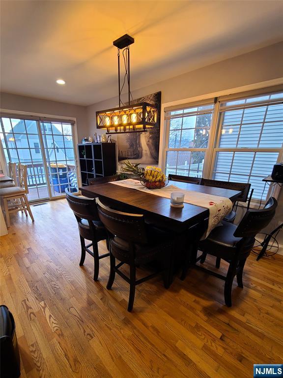 dining area with wood finished floors and recessed lighting