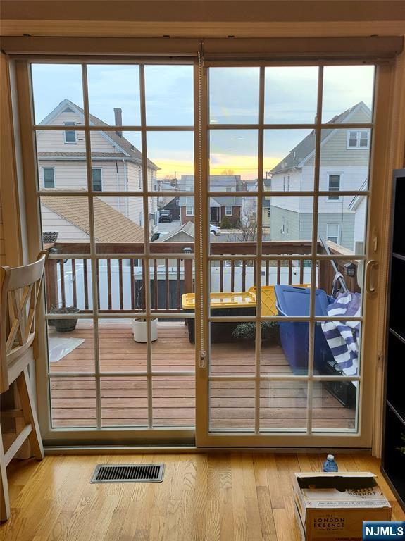 doorway to outside featuring visible vents and wood finished floors