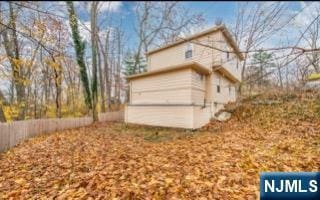 view of side of property featuring fence