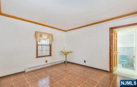 spare room featuring ornamental molding and baseboard heating