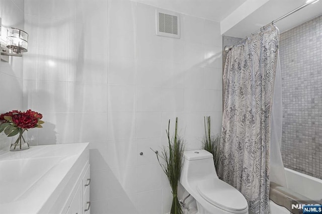 full bathroom with shower / bath combo, visible vents, tile walls, and toilet