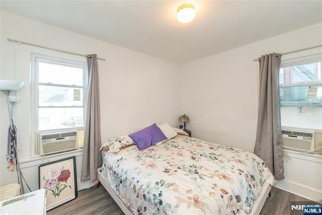 bedroom with wood finished floors and cooling unit