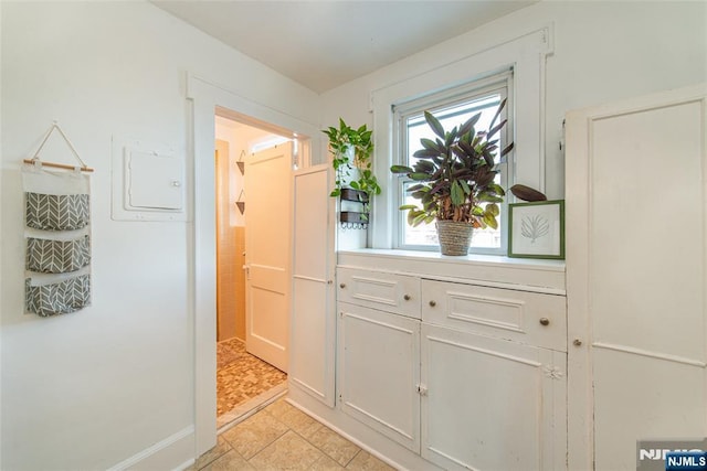 hall with light tile patterned flooring