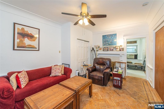 living area with a ceiling fan and cooling unit