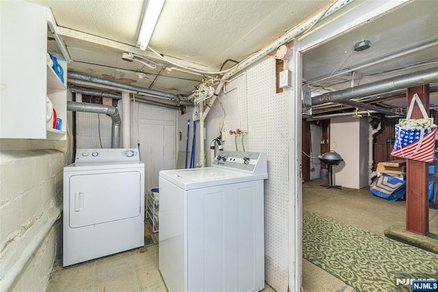 washroom featuring laundry area and washing machine and clothes dryer