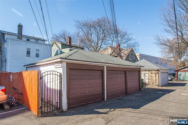 garage with a gate and fence