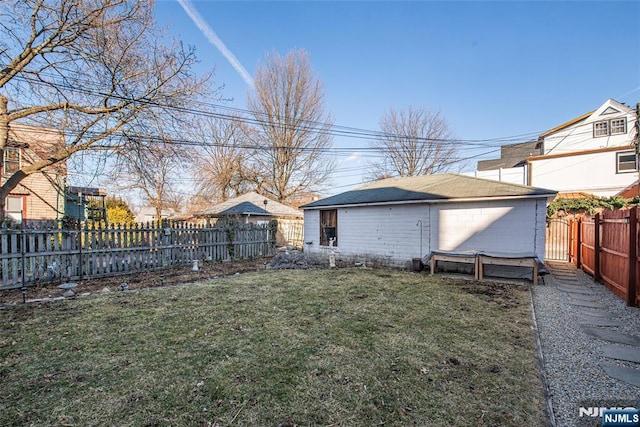 view of yard featuring a fenced backyard and an outdoor structure