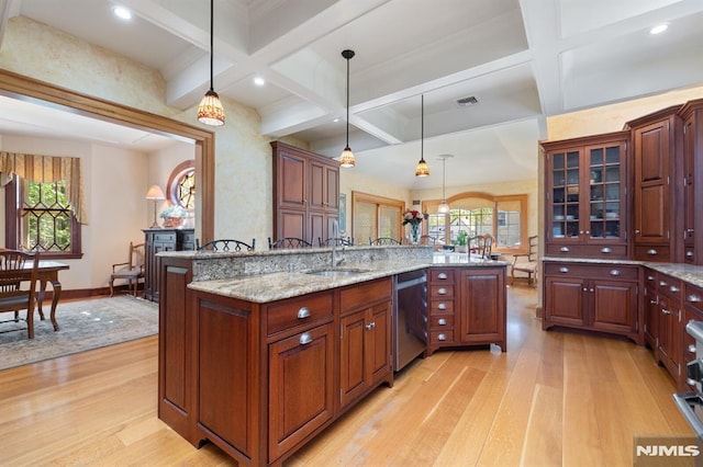 kitchen with a sink, light wood-style flooring, and coffered ceiling