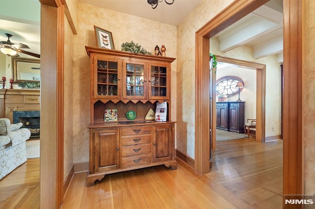 hallway featuring baseboards and light wood-style floors