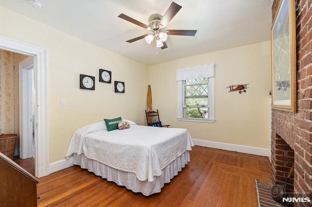 bedroom featuring baseboards, ceiling fan, and wood finished floors