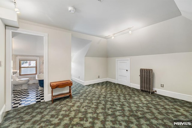 bonus room featuring baseboards, carpet, radiator heating unit, and lofted ceiling