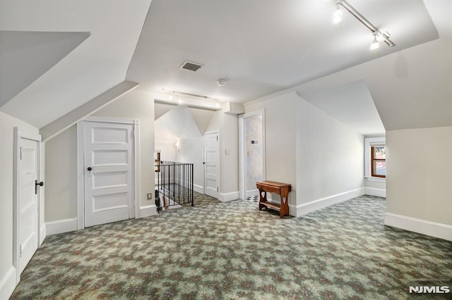 bonus room with carpet floors, baseboards, visible vents, and vaulted ceiling