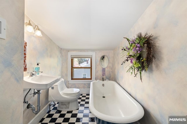29 Raymond Ave, Rutherford, NJ 07070 - bathroom with toilet, tile patterned floors, a freestanding bath, and baseboards