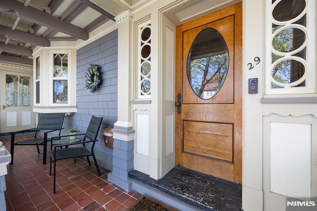 view of exterior entry with covered porch