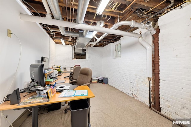 home office with carpet flooring and brick wall