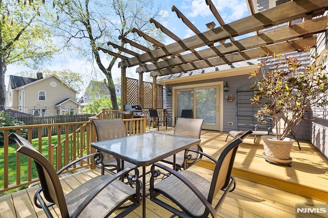 deck featuring a yard, a pergola, fence, and outdoor dining space