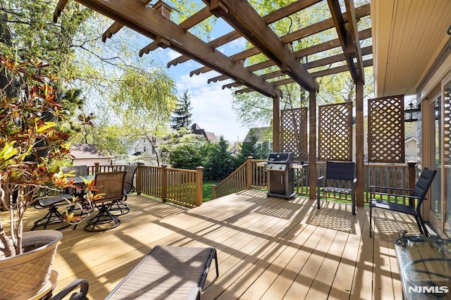 wooden terrace with outdoor dining space, a pergola, and area for grilling