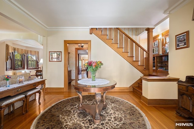entrance foyer with crown molding, baseboards, and stairs