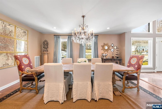 dining area with an inviting chandelier, light wood-style floors, and recessed lighting