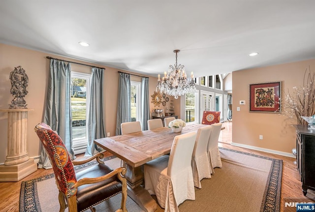 dining area featuring a chandelier, recessed lighting, baseboards, and light wood-style floors