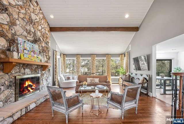 interior space featuring lofted ceiling with beams and a fireplace