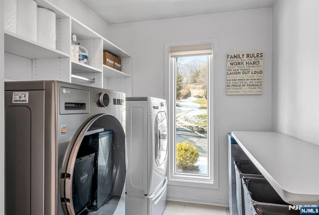 laundry area with laundry area and washer and clothes dryer