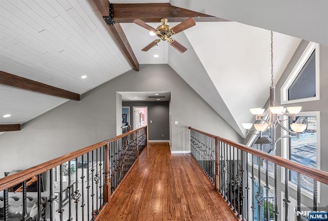 corridor featuring recessed lighting, lofted ceiling with beams, an inviting chandelier, wood finished floors, and baseboards