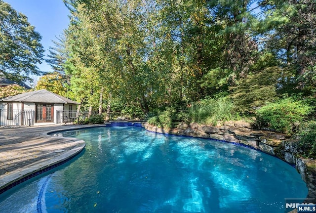 pool featuring fence and a patio