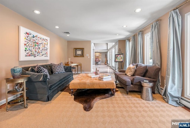 living room with light colored carpet, recessed lighting, visible vents, and baseboards