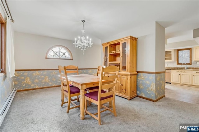 dining room featuring light carpet, wallpapered walls, and a baseboard heating unit