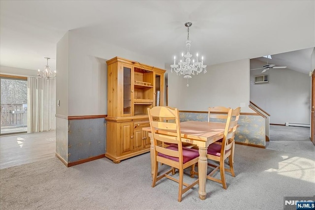 dining area featuring light colored carpet, a baseboard heating unit, vaulted ceiling, baseboards, and ceiling fan with notable chandelier