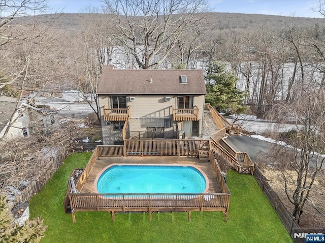 view of swimming pool featuring a lawn and a fenced in pool