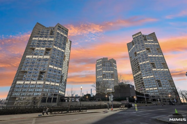 property at dusk featuring a city view