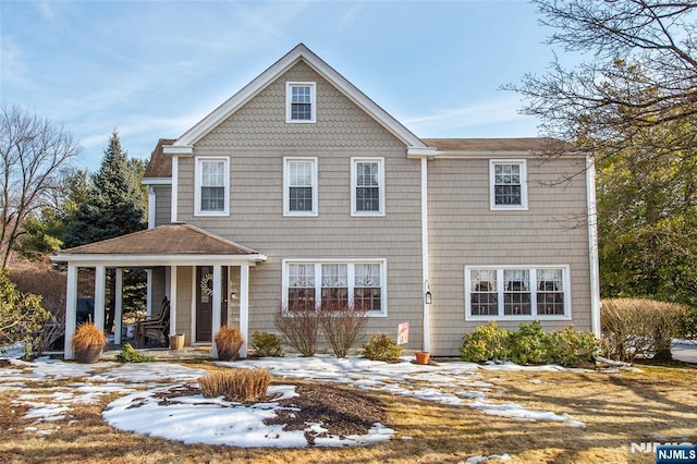 shingle-style home featuring covered porch