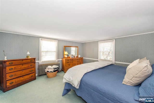 carpeted bedroom with baseboards, radiator, ornamental molding, and wallpapered walls