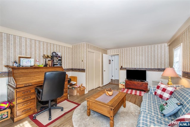 home office featuring wallpapered walls and light wood-style floors