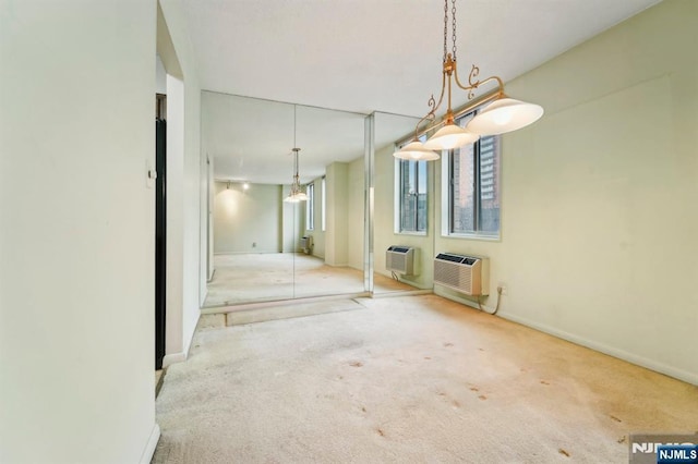 interior space featuring carpet floors, an AC wall unit, a wall mounted AC, and baseboards