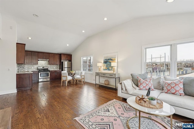 living room with lofted ceiling, dark wood-style flooring, baseboards, and recessed lighting