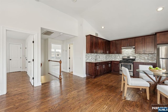 kitchen with stainless steel appliances, light countertops, a sink, and dark wood-type flooring