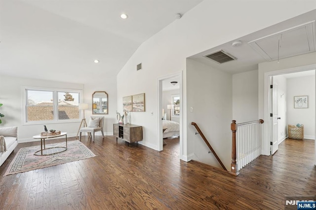 living area with recessed lighting, wood finished floors, visible vents, baseboards, and attic access