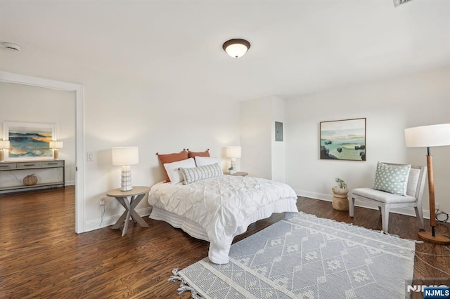 bedroom with wood finished floors and baseboards