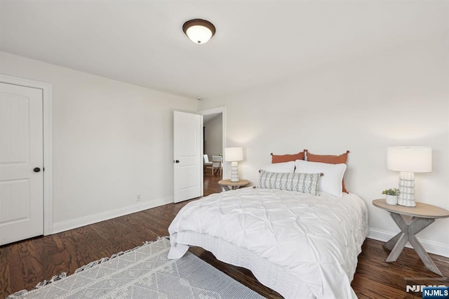 bedroom featuring wood finished floors and baseboards