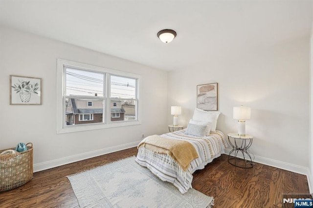 bedroom with wood finished floors and baseboards