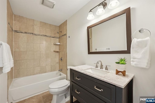 bathroom with tile patterned flooring, shower / tub combination, vanity, and toilet