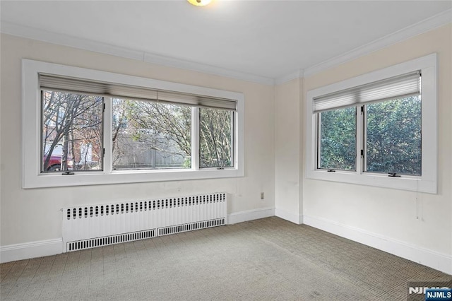 carpeted empty room featuring ornamental molding, radiator, and baseboards