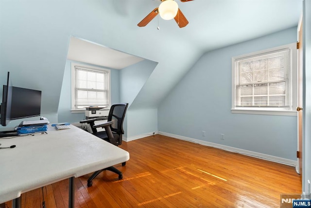 office area featuring baseboards, lofted ceiling, light wood-style floors, and ceiling fan