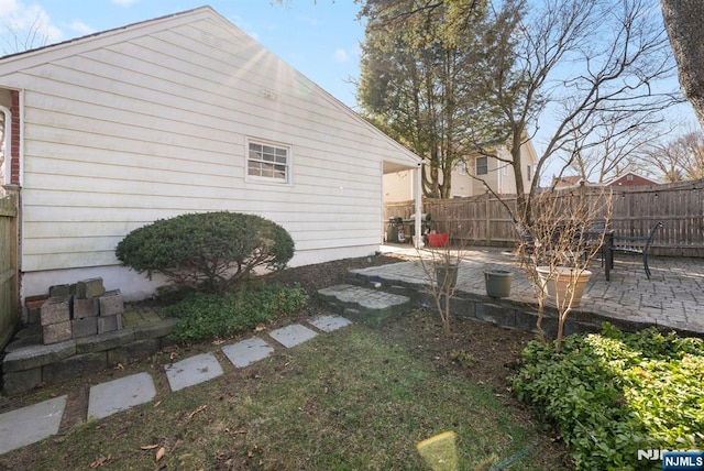 view of yard featuring fence and a patio area