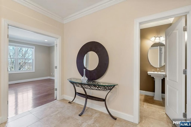 hallway featuring light tile patterned floors, ornamental molding, and baseboards